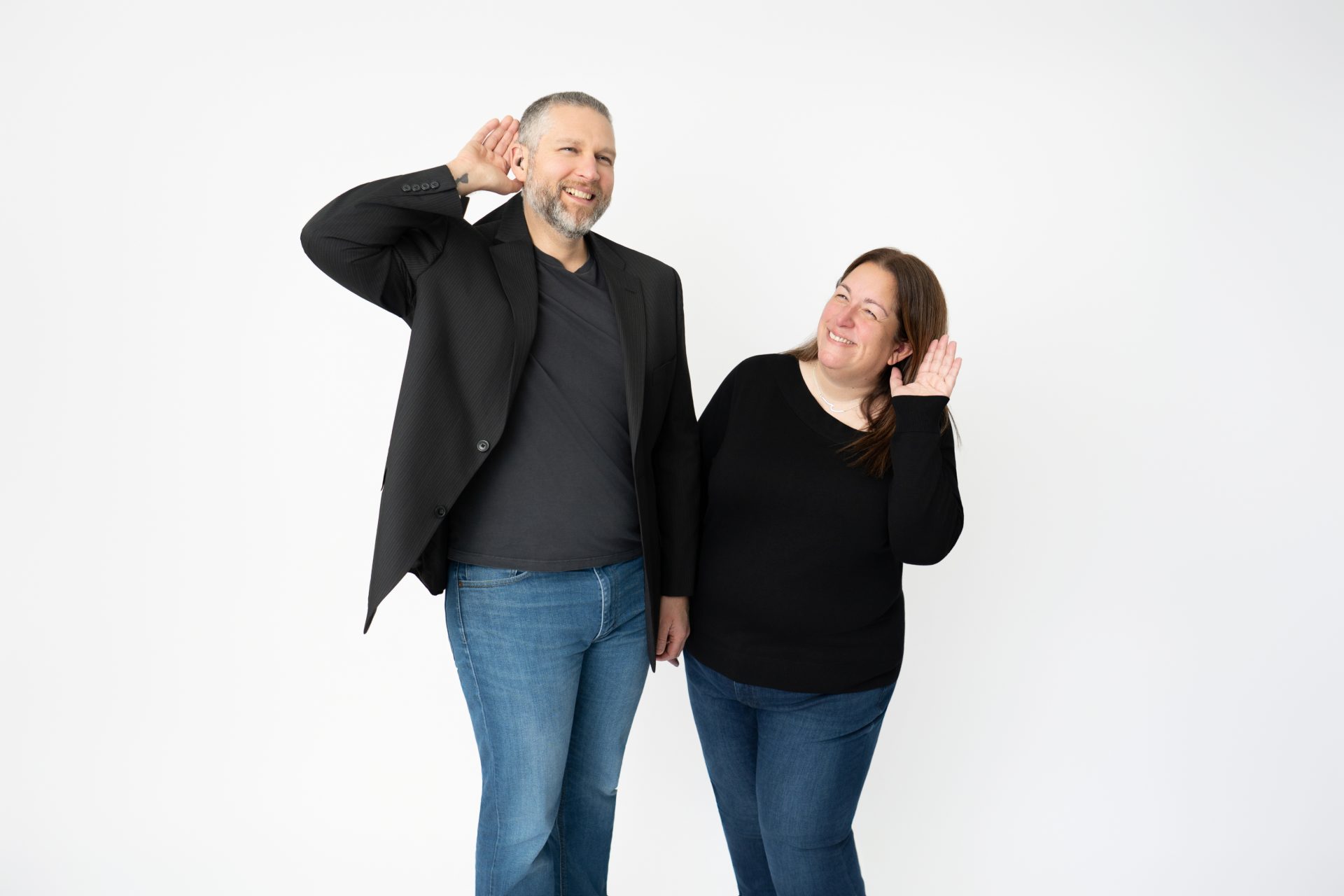 Brad and Julie with a hand to their ears
